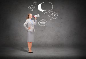 business, communication and office concept - smiling businesswoman with megaphone screaming at someone imaginary